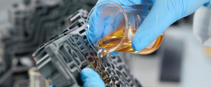 Male mechanic pour purified oil on automobile part, lubricating transport