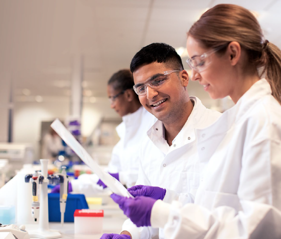 Two scientists looking at a document in a lab